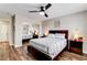 Comfortable bedroom with mirrored closet doors, wood floors, and neutral decor at 301 E Longacres Dr, Henderson, NV 89015