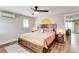 Cozy bedroom with a wooden bed frame, stylish nightstands, and a ceiling fan at 301 E Longacres Dr, Henderson, NV 89015