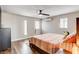 Inviting bedroom featuring a striped quilt, ceiling fan, and bright natural light at 301 E Longacres Dr, Henderson, NV 89015