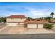 Spacious two-story home featuring a multi-car garage and a well-maintained front yard at 301 E Longacres Dr, Henderson, NV 89015