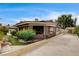 Beautifully landscaped home exterior with a charming covered patio and mature trees at 301 E Longacres Dr, Henderson, NV 89015