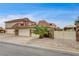 A three-car garage alongside a gated entrance with a lovely Palm tree at 301 E Longacres Dr, Henderson, NV 89015
