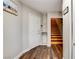 Hallway with wood floors and stairs leading to another level in the home at 301 E Longacres Dr, Henderson, NV 89015