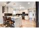 Bright, modern kitchen with white cabinets, marble countertops, and stainless steel appliances at 301 E Longacres Dr, Henderson, NV 89015