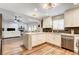 Modern kitchen with stainless appliances, white cabinets, marble counters and open to the living room at 301 E Longacres Dr, Henderson, NV 89015