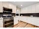 Modern kitchen featuring stainless steel appliances and white cabinets and stylish counters at 301 E Longacres Dr, Henderson, NV 89015