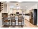 Updated kitchen with white cabinetry, stainless steel appliances, and modern lighting at 301 E Longacres Dr, Henderson, NV 89015