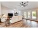 Bright living room with hardwood floors, a fireplace, and french doors to backyard at 301 E Longacres Dr, Henderson, NV 89015