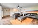 Comfortable living room with wood-look floors, ceiling fan, and modern furnishings at 301 E Longacres Dr, Henderson, NV 89015