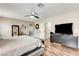 Primary bedroom featuring a ceiling fan, hardwood floors, and a walk-in closet at 301 E Longacres Dr, Henderson, NV 89015
