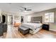 Spacious primary bedroom features hardwood floors, a walk-in closet, and neutral paint at 301 E Longacres Dr, Henderson, NV 89015