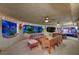 A covered outdoor living space with ceiling fans and ample seating at 301 E Longacres Dr, Henderson, NV 89015