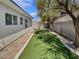 Backyard featuring artificial turf, mature trees, and block wall at 3109 W Colton Ave, North Las Vegas, NV 89032