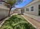 Private backyard with artificial turf, concrete perimeter, and desert landscaping at 3109 W Colton Ave, North Las Vegas, NV 89032