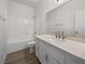 Beautiful bathroom with a tub, shower, modern vanity, white cabinets and wood style flooring at 3109 W Colton Ave, North Las Vegas, NV 89032