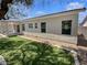 Exterior view of home featuring a covered patio and artificial turf backyard at 3109 W Colton Ave, North Las Vegas, NV 89032