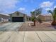 Charming single-story home featuring desert landscaping, a two-car garage, and a welcoming facade at 3109 W Colton Ave, North Las Vegas, NV 89032
