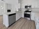 Modern kitchen features stainless steel appliances, white cabinetry, and quartz countertops at 3109 W Colton Ave, North Las Vegas, NV 89032