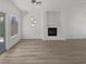 Bright living room featuring wood style flooring, fireplace, modern light fixtures, and plenty of natural light at 3109 W Colton Ave, North Las Vegas, NV 89032