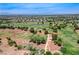 Expansive aerial view of a golf course community with manicured greens and a stunning mountain backdrop at 3307 Forestina Ct, Las Vegas, NV 89122