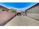 Wide shot of home's backyard area with gravel, patio, and block wall at 3307 Forestina Ct, Las Vegas, NV 89122