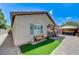 Beautiful backyard area featuring stone pavers, artificial turf, and an outdoor dining set at 3307 Forestina Ct, Las Vegas, NV 89122
