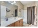 Bright bathroom featuring a shower-tub combo with a neutral vanity and artistic desert wall decor at 3307 Forestina Ct, Las Vegas, NV 89122