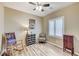 Bedroom with bright natural light, stylish ceiling fan, and a blend of classic and unique furnishings at 3307 Forestina Ct, Las Vegas, NV 89122