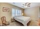 Neutral bedroom featuring a ceiling fan, plantation shutters, carpet, and a comfortable queen bed at 3307 Forestina Ct, Las Vegas, NV 89122