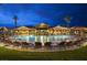 Well-lit community pool with plenty of lounge chairs and tables at 3307 Forestina Ct, Las Vegas, NV 89122