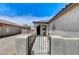 View of the front entrance with gated entry, walkway, and desert landscaping at 3307 Forestina Ct, Las Vegas, NV 89122