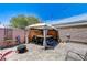 Outdoor hot tub with a bar under a gazebo, accented by decorative flowers and brick paving at 3307 Forestina Ct, Las Vegas, NV 89122