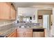 Well-lit kitchen featuring granite countertops, stainless steel dishwasher, and a view to the living area at 3307 Forestina Ct, Las Vegas, NV 89122