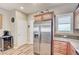 Kitchen with stainless steel refrigerator, light wood cabinets and drawers, granite countertop, and a wine rack at 3307 Forestina Ct, Las Vegas, NV 89122