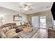 Cozy living room with wood floors, a ceiling fan, and comfortable seating arrangement at 3307 Forestina Ct, Las Vegas, NV 89122