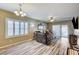 Comfortable living room with wood flooring, plantation shutters, and sliding door access to the patio at 3307 Forestina Ct, Las Vegas, NV 89122