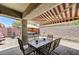 Relaxing covered patio with an extendable awning, dining table, and a view of the outdoor hot tub at 3307 Forestina Ct, Las Vegas, NV 89122