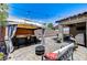 Outdoor patio area complete with a bar, dining set, lounge seating, and a fire pit at 3307 Forestina Ct, Las Vegas, NV 89122