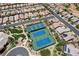 Aerial view of tennis courts, adjacent homes, landscaping, and walking paths in a sunny community in Nevada at 3307 Forestina Ct, Las Vegas, NV 89122