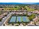 Overhead view of blue tennis courts surrounded by lush landscaping and well-maintained homes on a bright, sunny day at 3307 Forestina Ct, Las Vegas, NV 89122