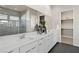 Elegant bathroom with dual sinks, white cabinets, and a glass-enclosed shower with modern fixtures at 344 Tigullio Ave, Henderson, NV 89011