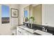 Bright bathroom featuring double sinks, white cabinets, and a large window with a view at 344 Tigullio Ave, Henderson, NV 89011