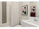 Modern bathroom with tiled shower/tub, white vanity, framed artwork, and stylish design at 344 Tigullio Ave, Henderson, NV 89011