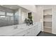 Bright bathroom with dual sinks, a long vanity, and a glass-enclosed shower reflected in the mirror at 344 Tigullio Ave, Henderson, NV 89011