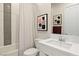 Modern bathroom with tiled shower/tub, white vanity, framed artwork, and stylish design at 344 Tigullio Ave, Henderson, NV 89011