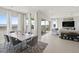 Bright dining area featuring large windows, contemporary furniture, and seamless flow into the living space at 344 Tigullio Ave, Henderson, NV 89011