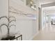 Hallway leading to a bright living space, featuring modern decor and elegant lighting at 344 Tigullio Ave, Henderson, NV 89011