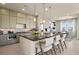 Open-concept kitchen featuring a large island with seating and seamless transition to the living and dining areas at 344 Tigullio Ave, Henderson, NV 89011