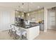 Modern kitchen with a large island, stylish pendant lighting, and stainless steel appliances at 344 Tigullio Ave, Henderson, NV 89011