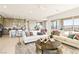 Open living space features hardwood floors, designer furniture, and access to a patio at 344 Tigullio Ave, Henderson, NV 89011